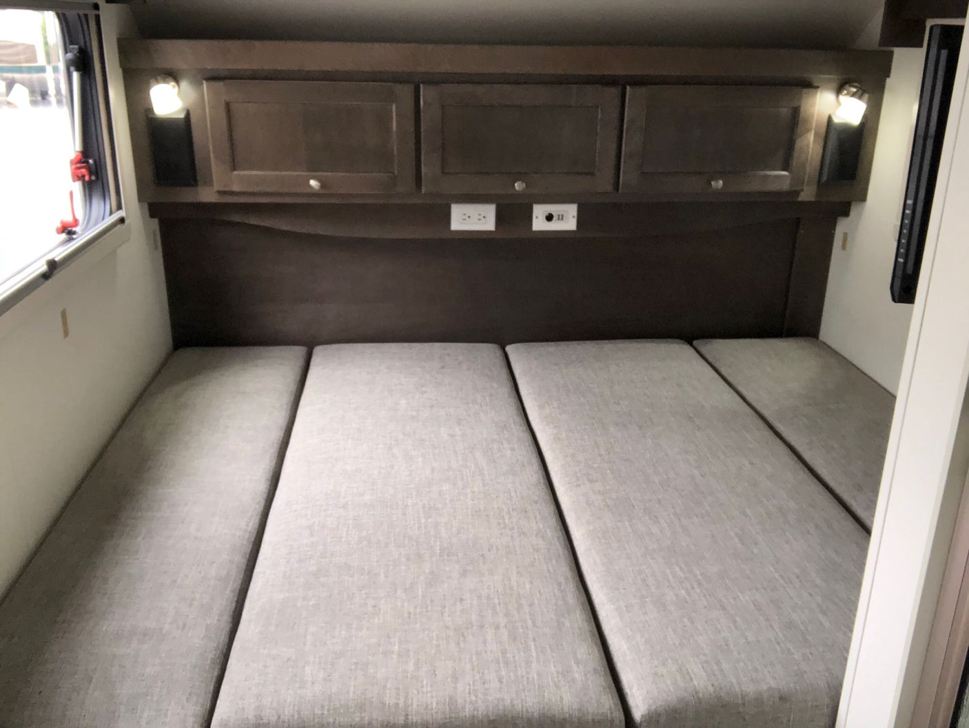 complete with outdoor mats & a bike.|White Subaru SUV hitched to a gray "Boondock Lite" teardrop trailer