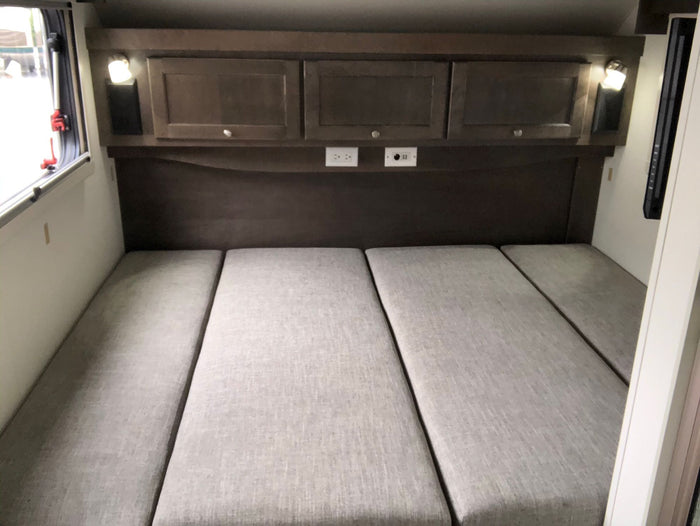 complete with outdoor mats & a bike.|White Subaru SUV hitched to a gray "Boondock Lite" teardrop trailer