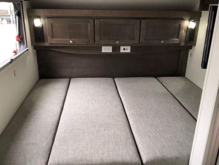 complete with outdoor mats & a bike.|White Subaru SUV hitched to a gray "Boondock Lite" teardrop trailer