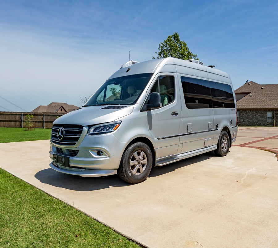 is parked on a sunny day.|Silver Airstream Interstate RV van