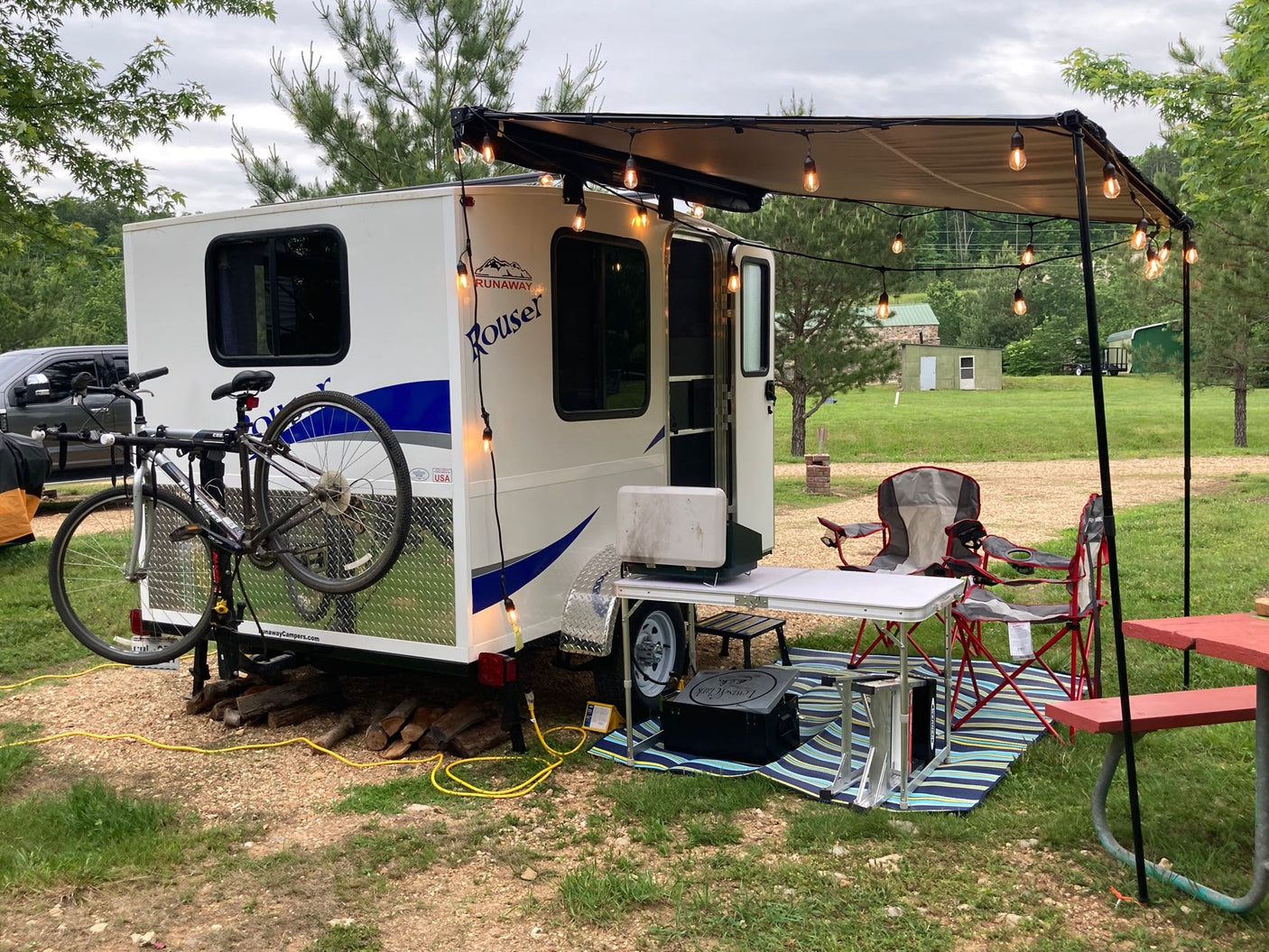 A small white rv rental camper