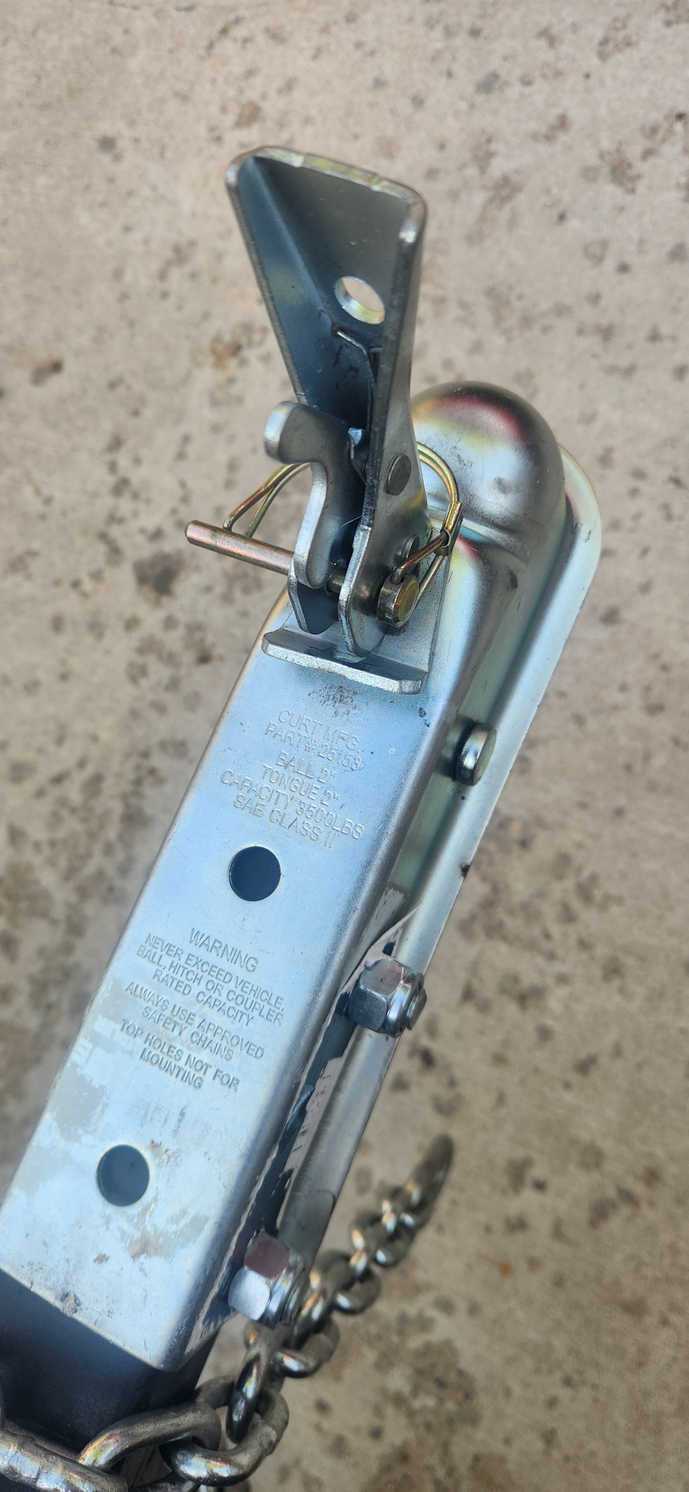This silver-colored trailer coupler, essential for an **RV rental** setup, displays its 3500lb **towing capacity** and warnings for safe **hitching**.