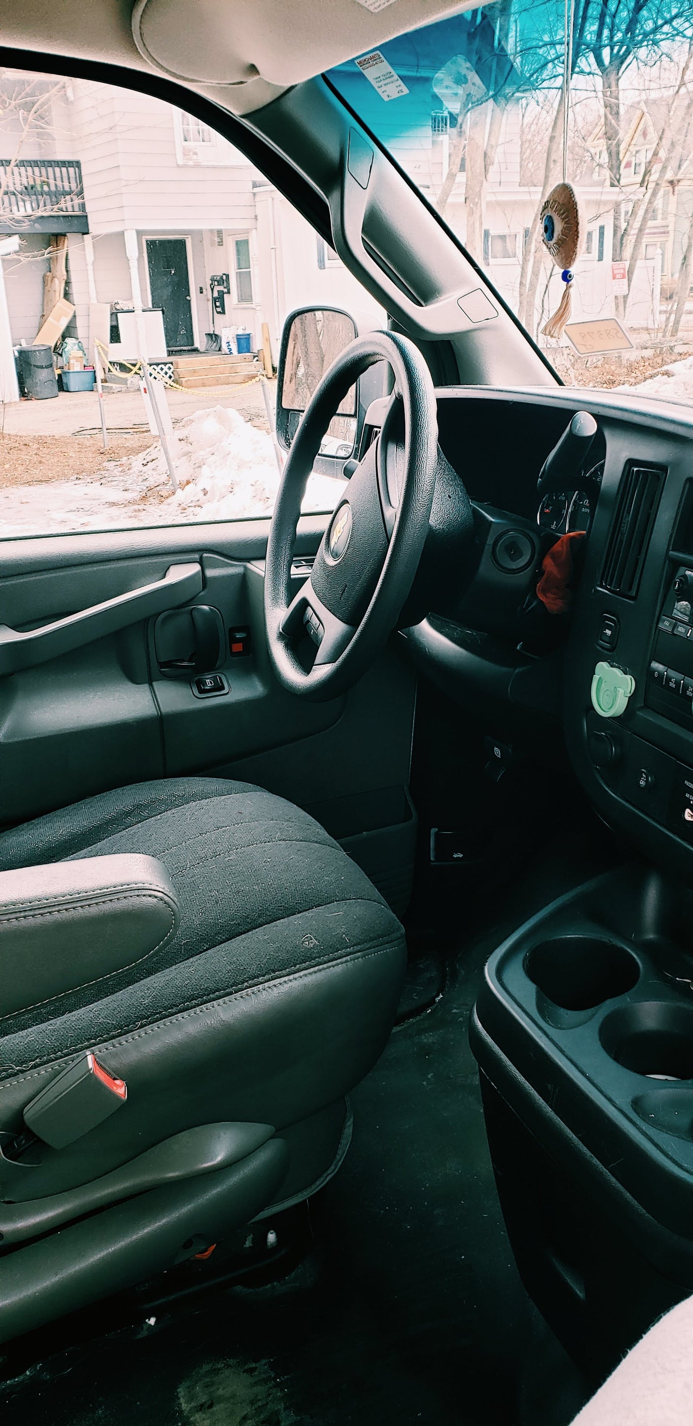 RV rental interior: driver's perspective showing the seat, dashboard, and a snowy outdoor view.