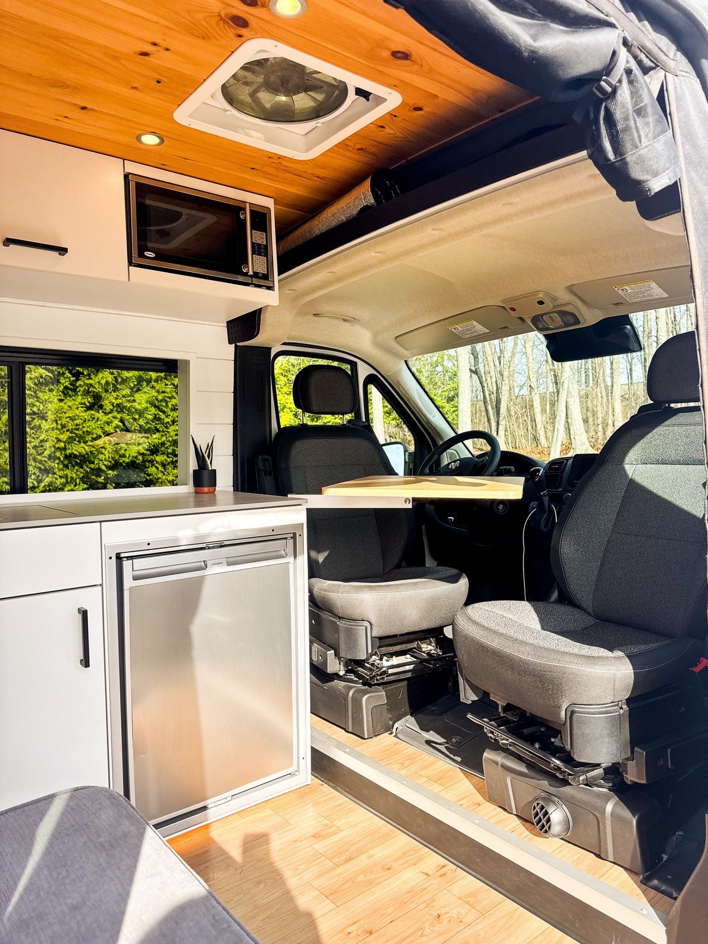 and a wooden ceiling.|Bright RV rental kitchen featuring a covered sink