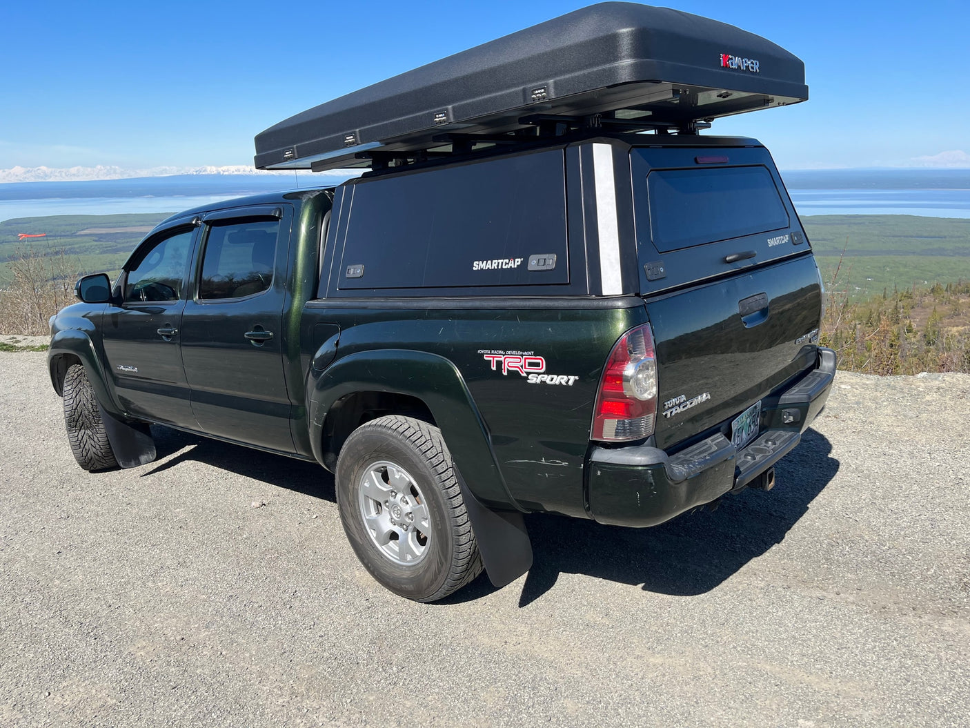 Toyota Tacoma with rooftop tent, a great RV rental alternative for exploring scenic mountain and lake views. Ideal for camping.