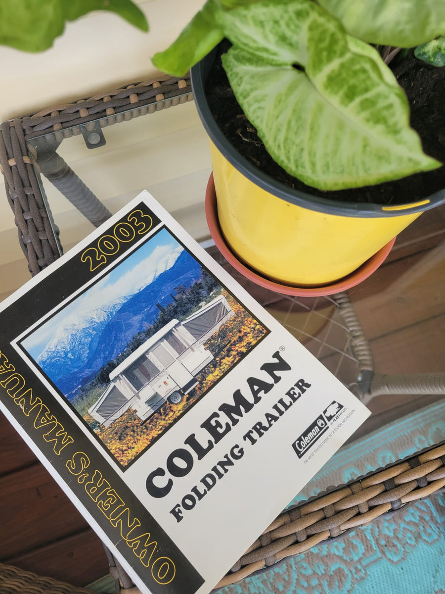 parked on a suburban driveway.|Pop-up camper