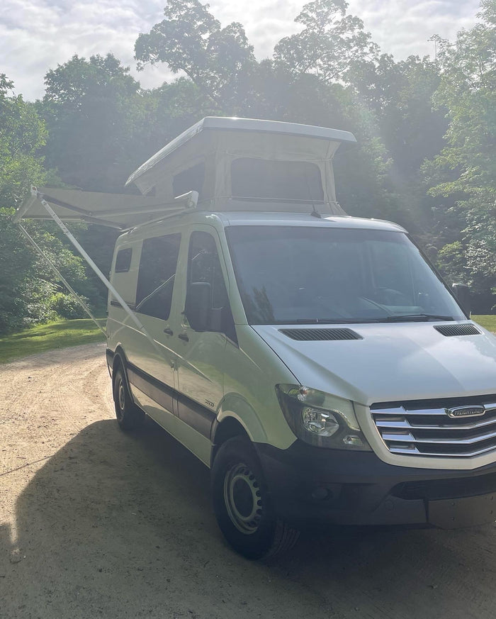 ideal for camping adventures.|This white Freightliner pop-top rv rental