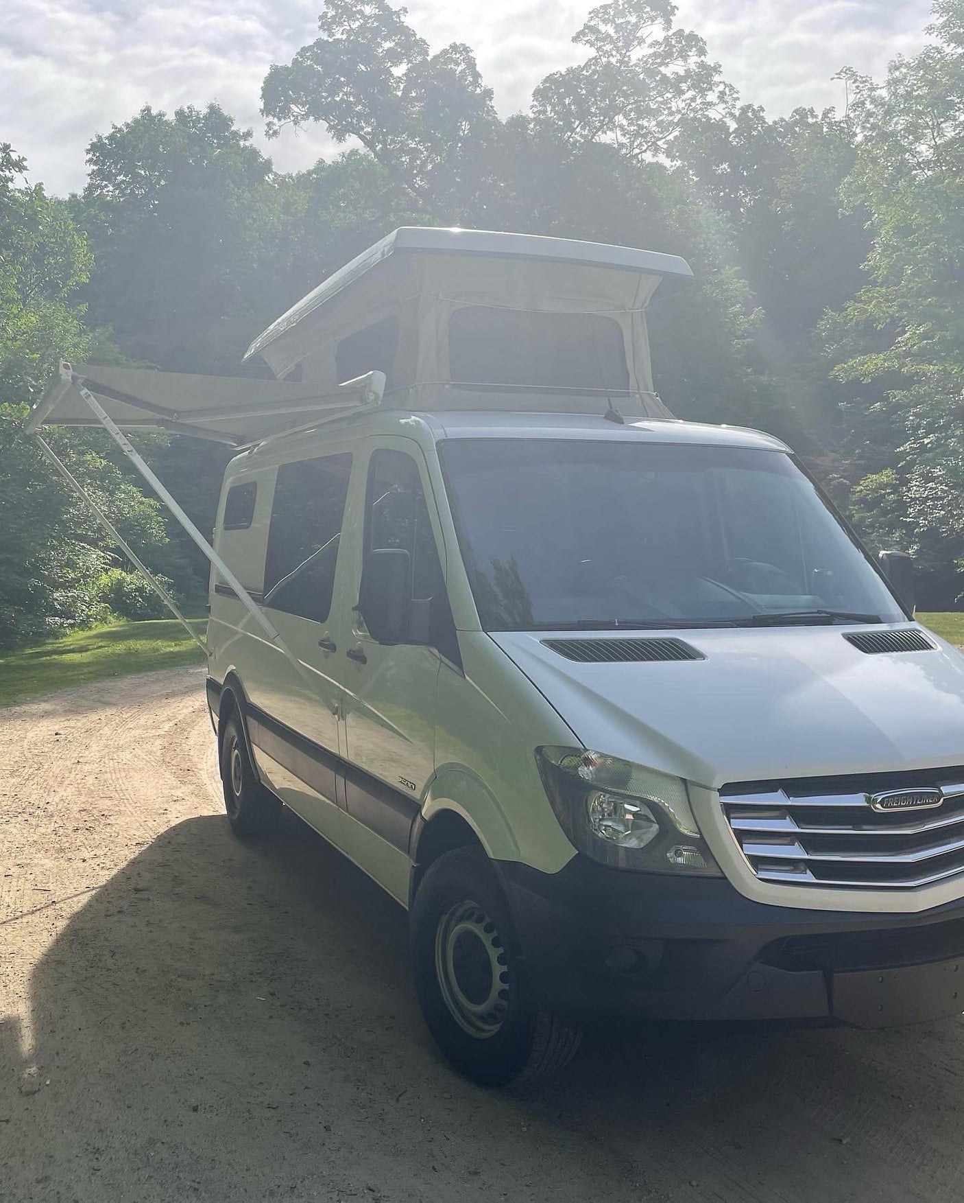ideal for camping adventures.|This white Freightliner pop-top rv rental