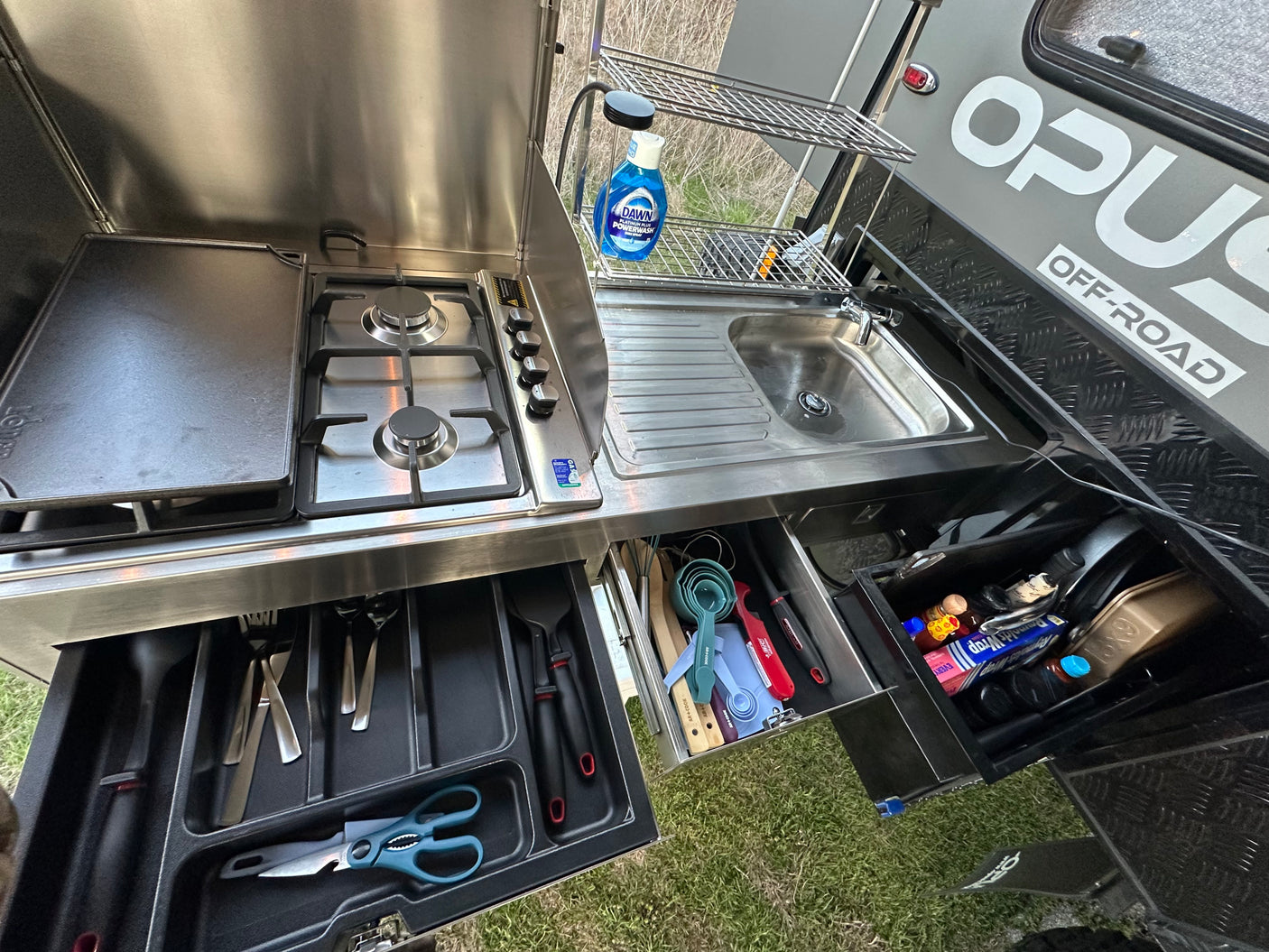 and seating area.|This off-road camper RV rental features a robust outdoor kitchen setup