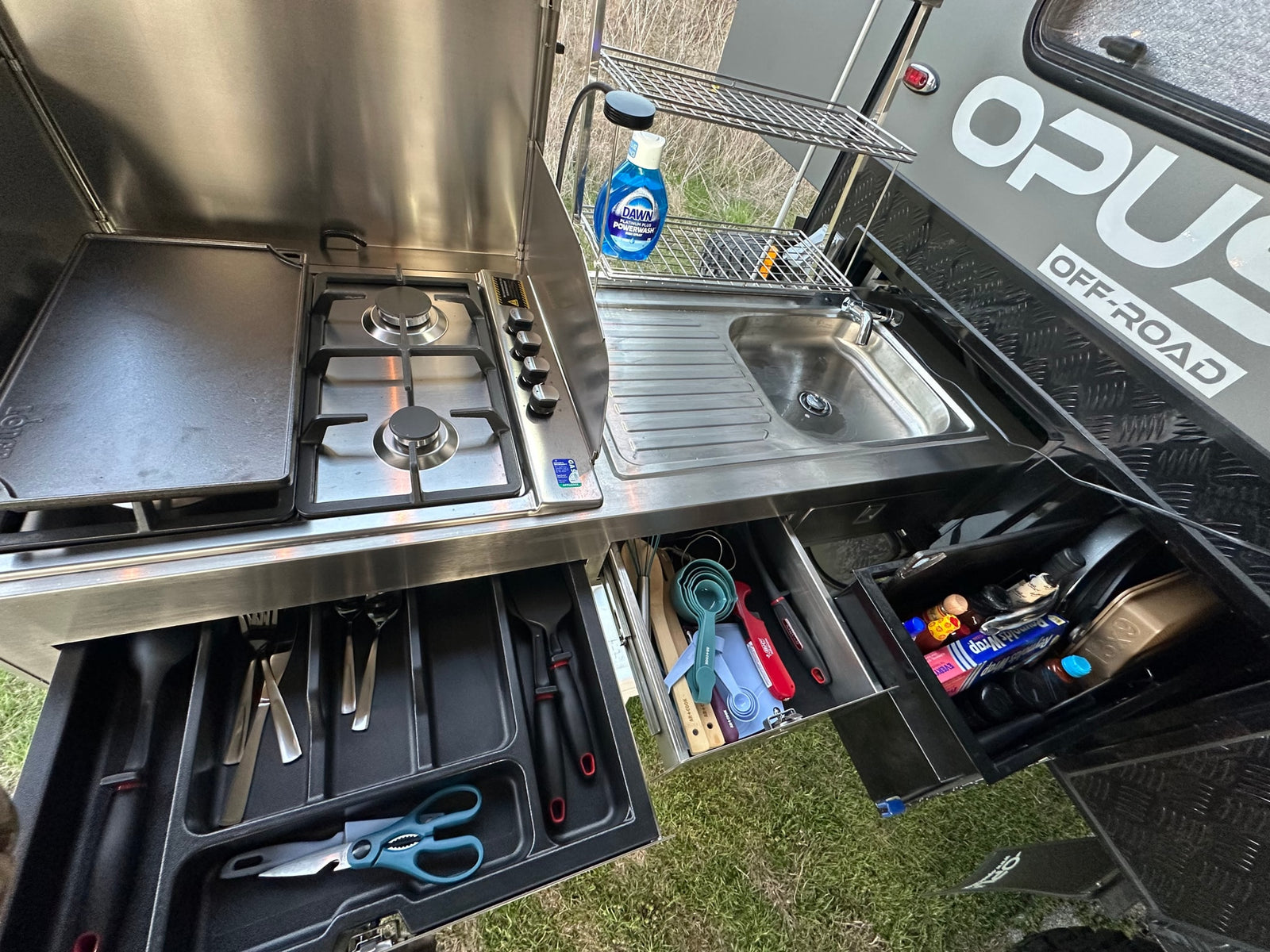 and seating area.|This off-road camper RV rental features a robust outdoor kitchen setup