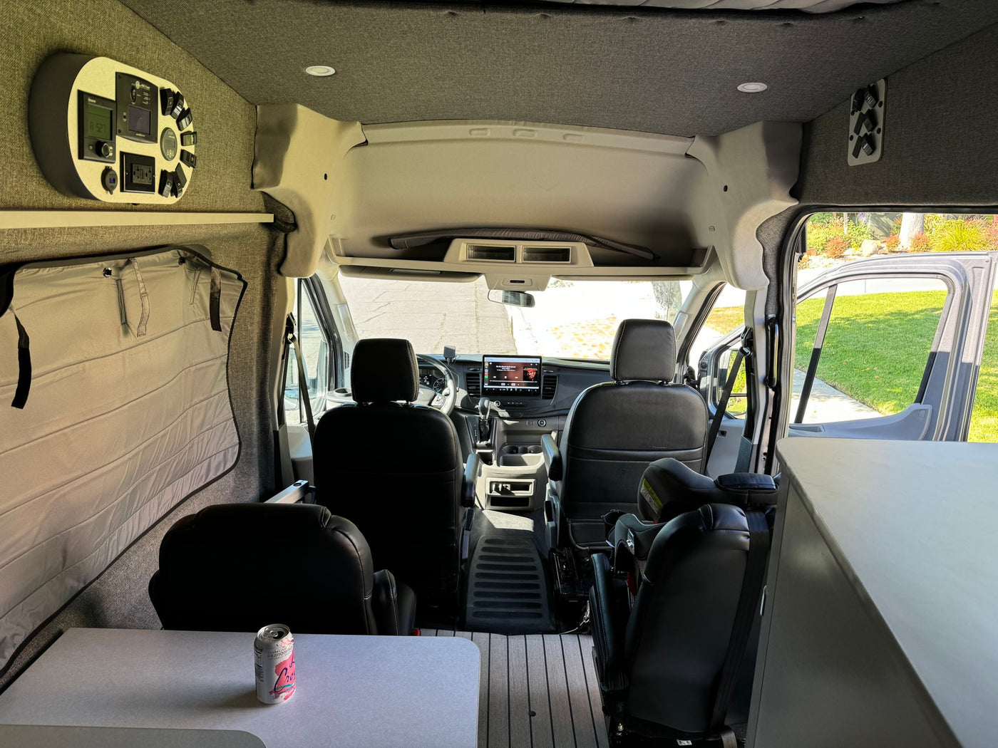 parked on a sunny street. Ready for any adventure.|This stylish gray Ford Transit camper van — photo 13