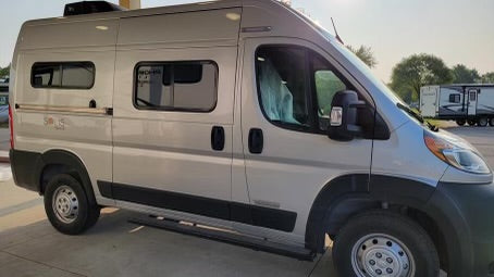Rent this modern grey camper van, a perfect RV rental for your next road trip adventure. Features side windows and AC.