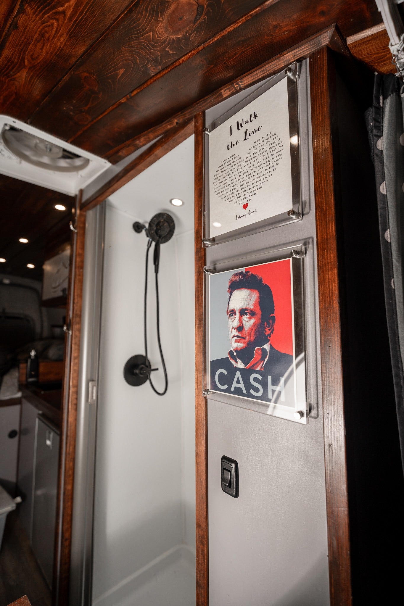 This RV rental boasts a stylish interior with a compact shower and Johnny Cash "I Walk the Line" art.