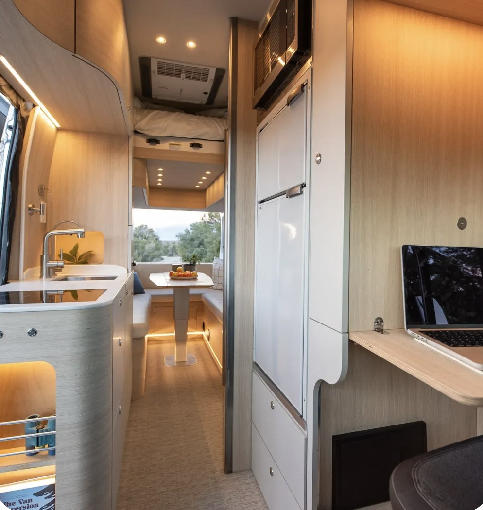 and bed area.|This luxurious RV rental showcases a modern kitchen