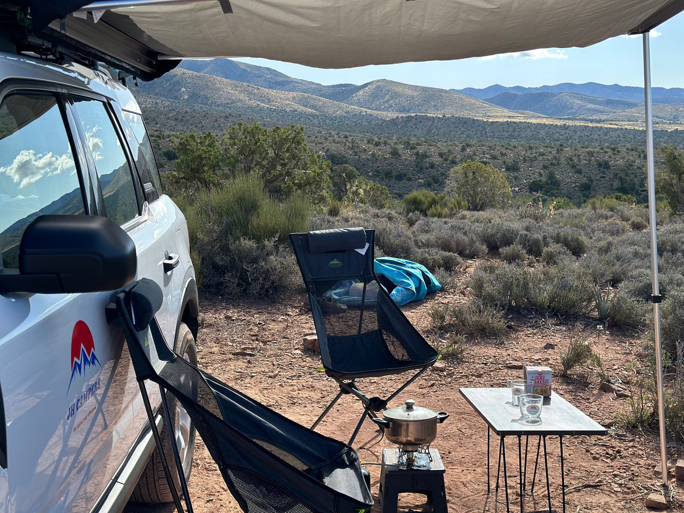 part of an RV rental outdoor adventure. Prepping for camp.|Inside an RV rental SUV: a clever camper setup with a bed platform