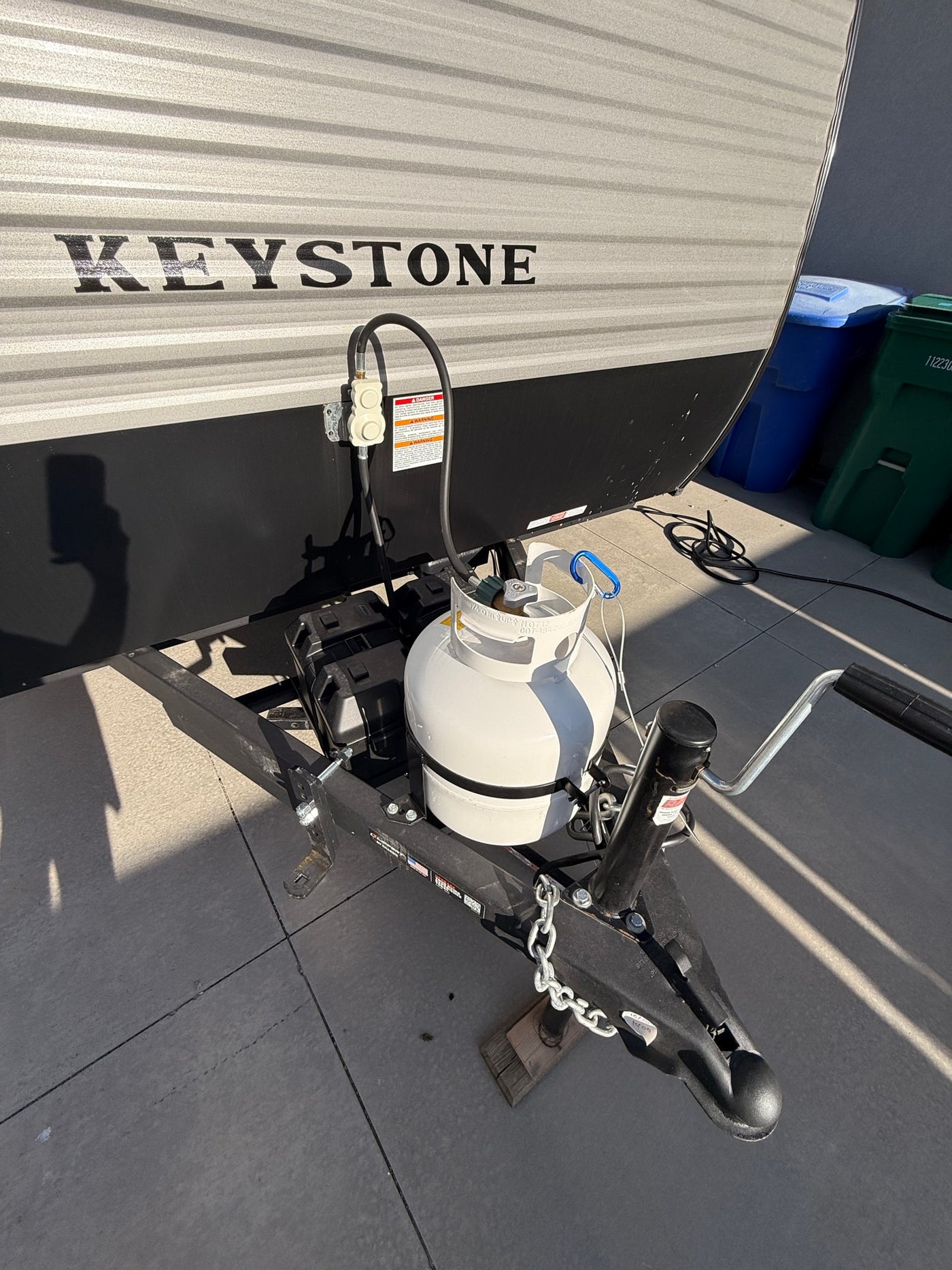 Keystone RV rental front with propane tank, battery, and hitch setup, ready for adventure. — photo 8