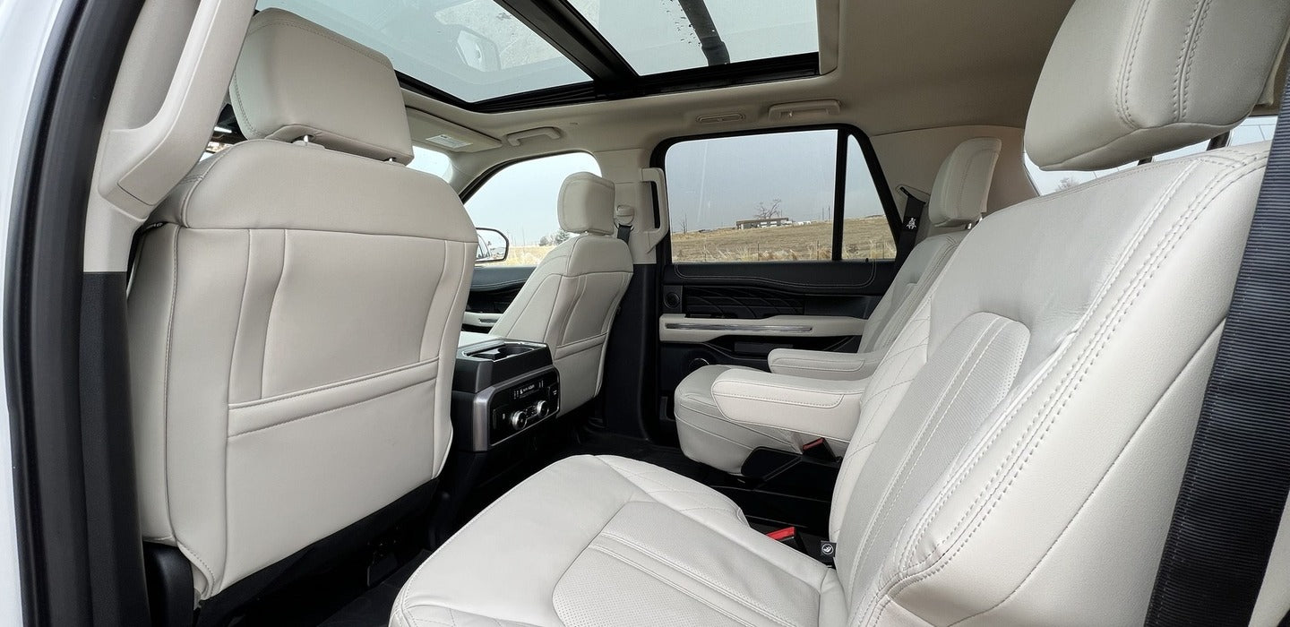 Spacious light-colored SUV interior features panoramic roof & leather seats. Perfect for a luxurious RV rental alternative.