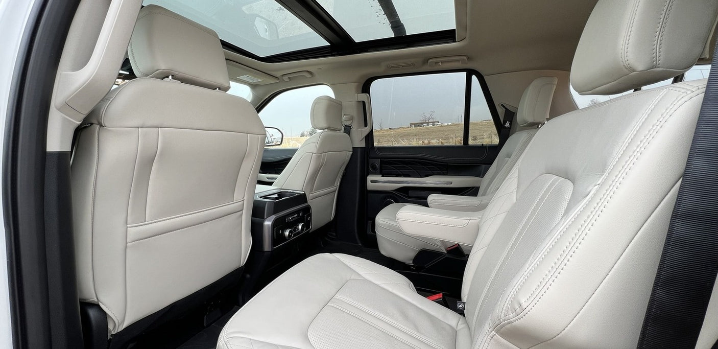 Spacious light-colored SUV interior features panoramic roof & leather seats. Perfect for a luxurious RV rental alternative.