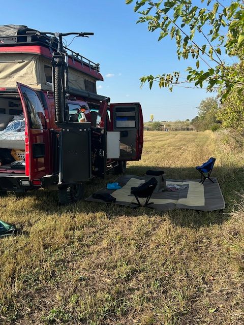 with a mat out.|Experience off-grid adventures with this red overland campervan