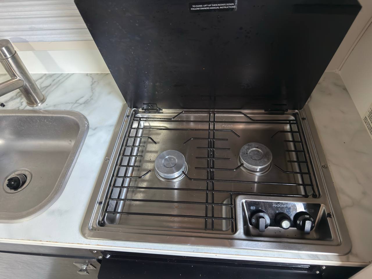 and TV for comfortable journeys.|Modern RV rental dinette featuring comfortable U-shaped seating