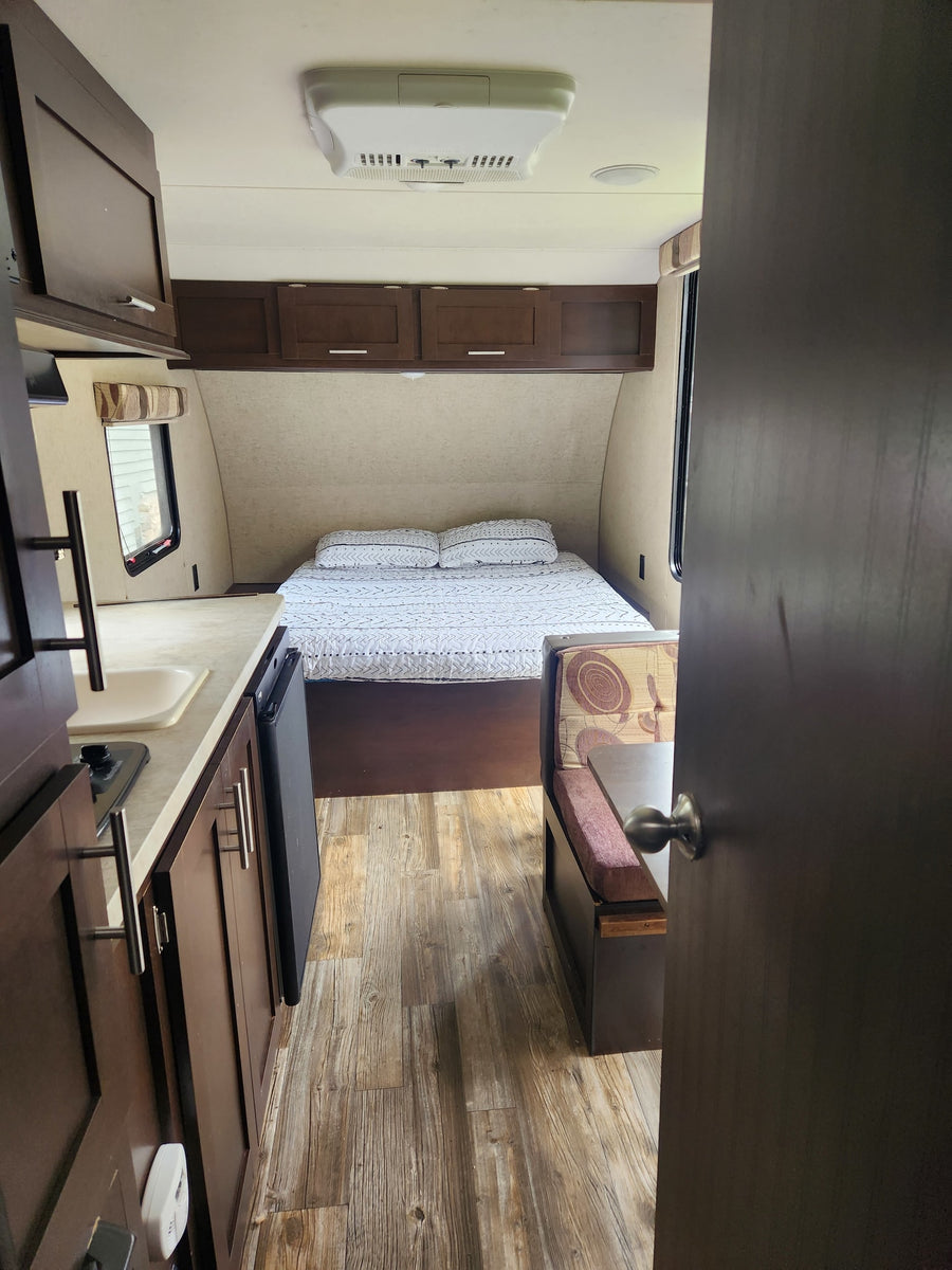 Interior view of an rv rental: a cozy bed