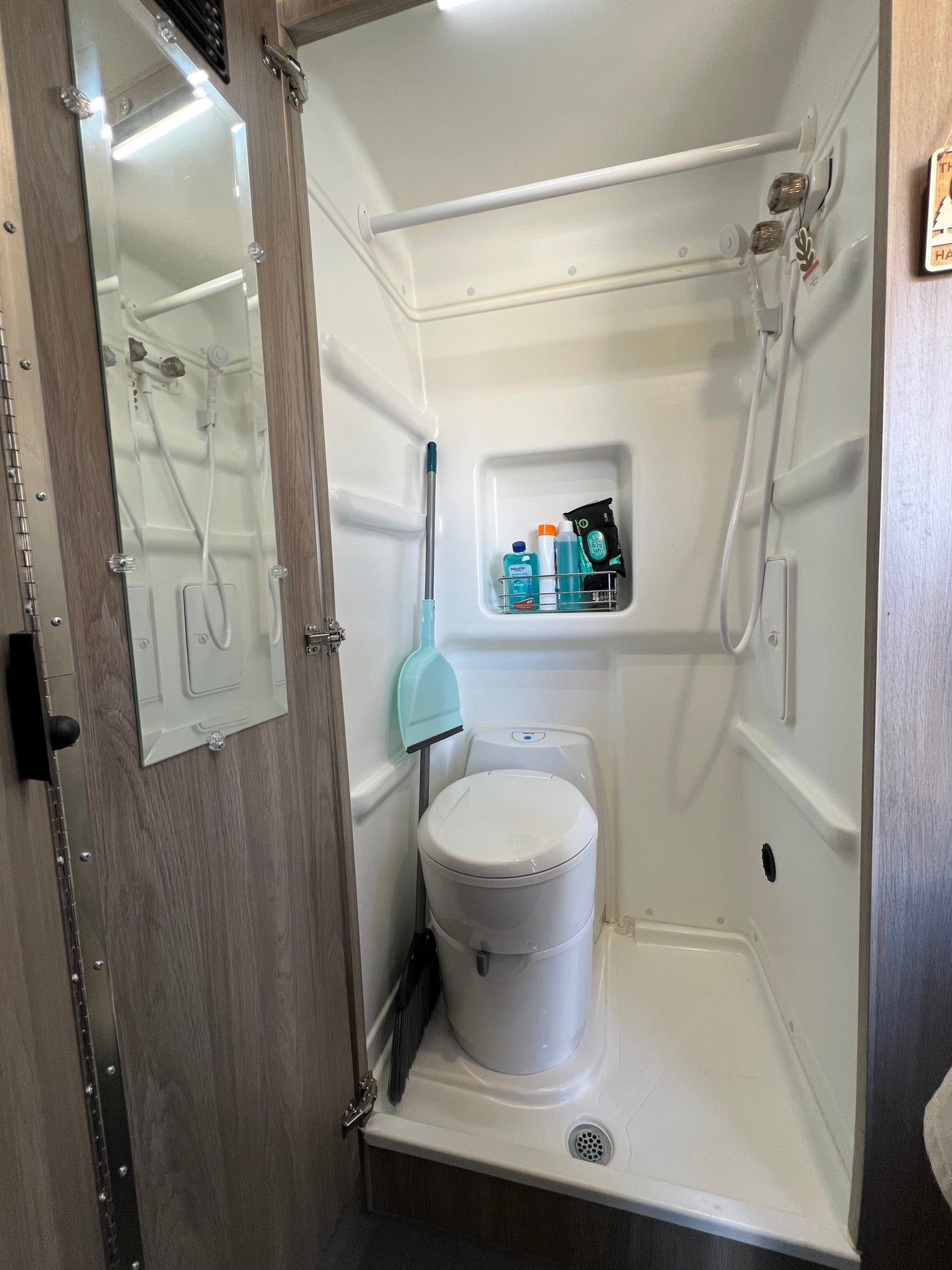 Compact RV rental bathroom with integrated shower, toilet, and toiletries. Practical wet bath design for travel. — photo 6