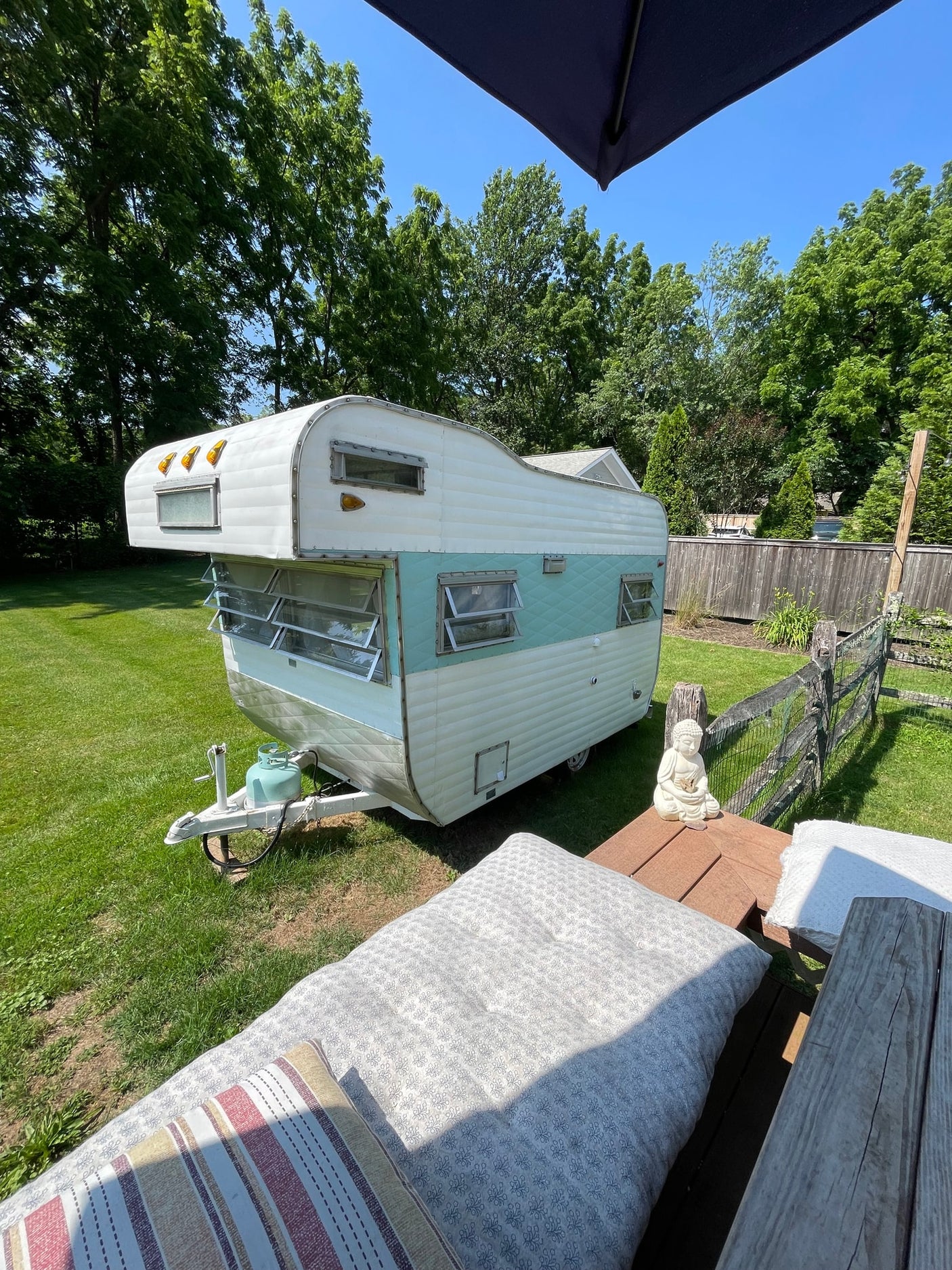 and a comfortable bed.|Cozy RV rental interior features a bed piled with white