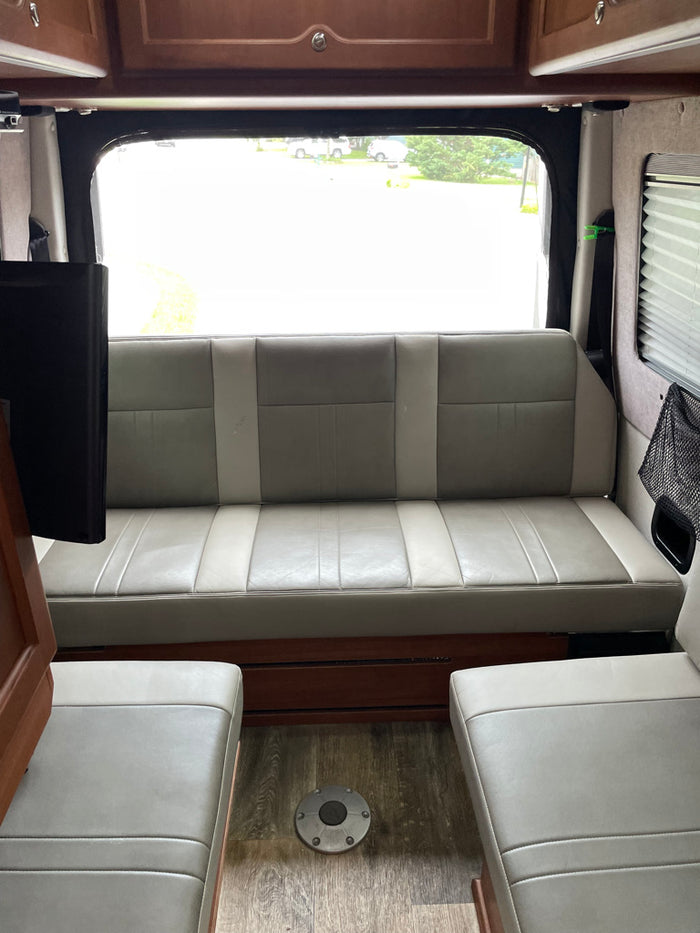 parked curbside. Dark tinted windows visible.|A white Mercedes-Benz Sprinter RV rental van with a sunshade