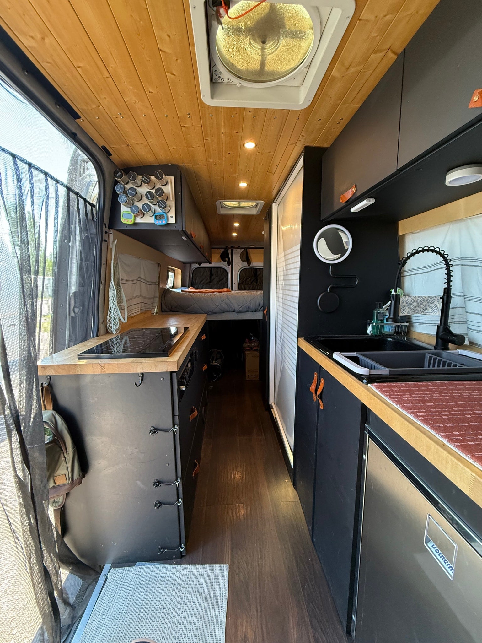 showcasing distant mountains under a blue sky.|RV rental van cabin: front seats