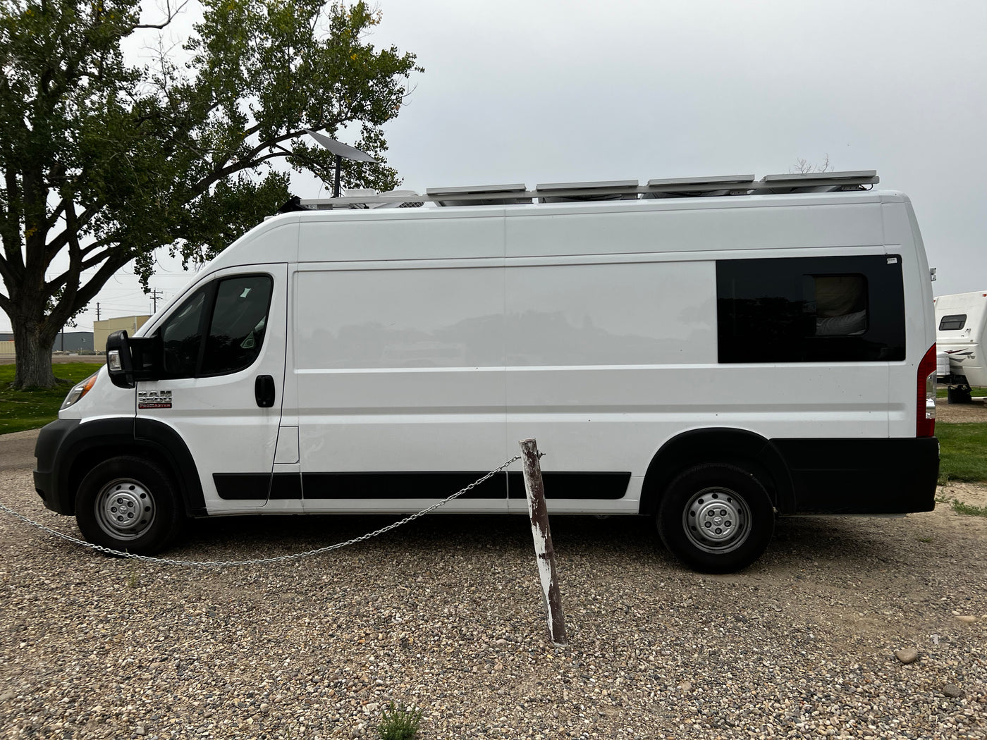 White Ram ProMaster camper van with solar panels & Starlink, ideal for RV rental adventures. — photo 12