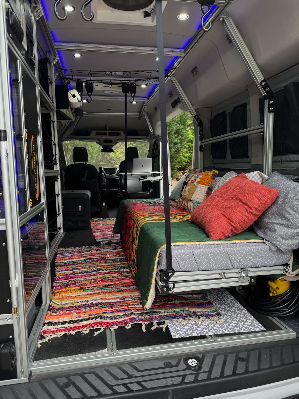 perfect for mobile adventures.|Explore in this comfy RV rental! Pet-friendly van with custom storage