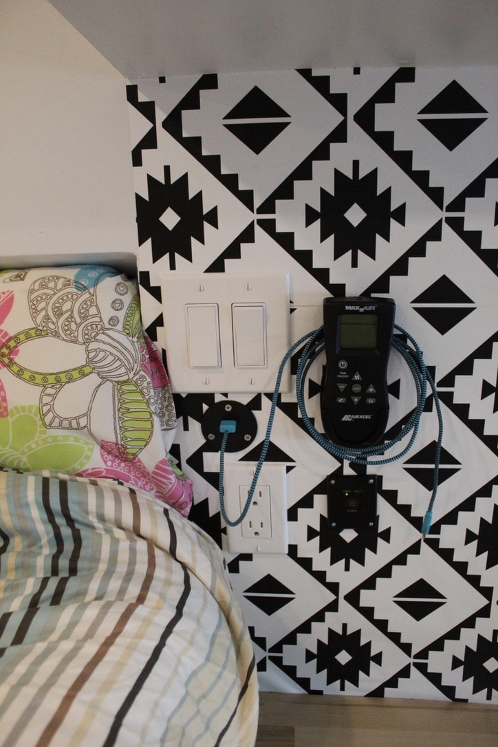 and stylish patterned accents.|Interior of an RV rental featuring a cozy bed