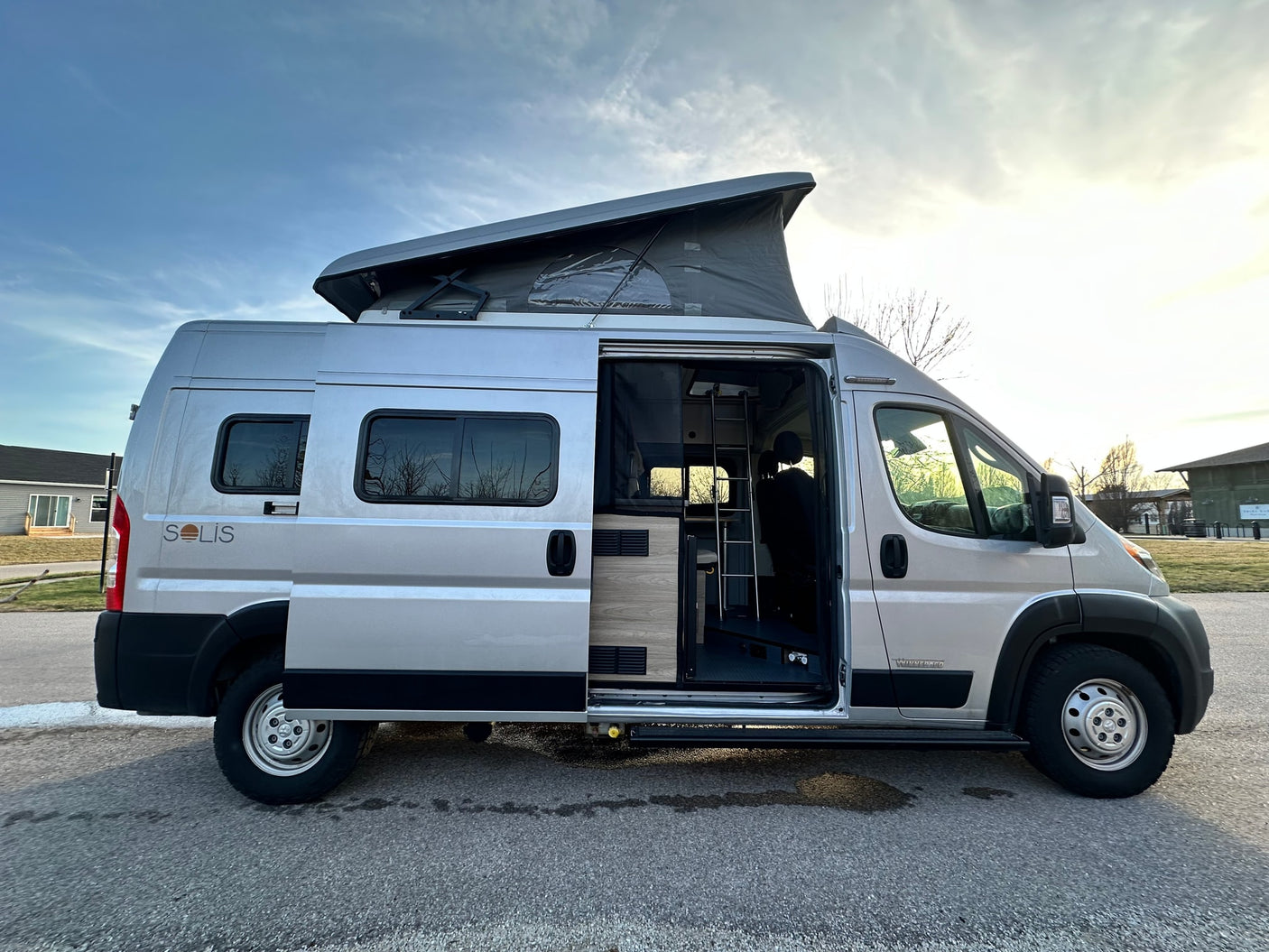 and personal care products for comfortable travel.|RV rental campervan interior featuring a compact kitchen