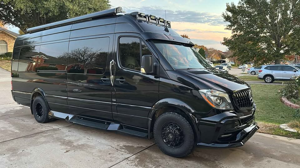 This sleek black Mercedes-Benz Sprinter camper van