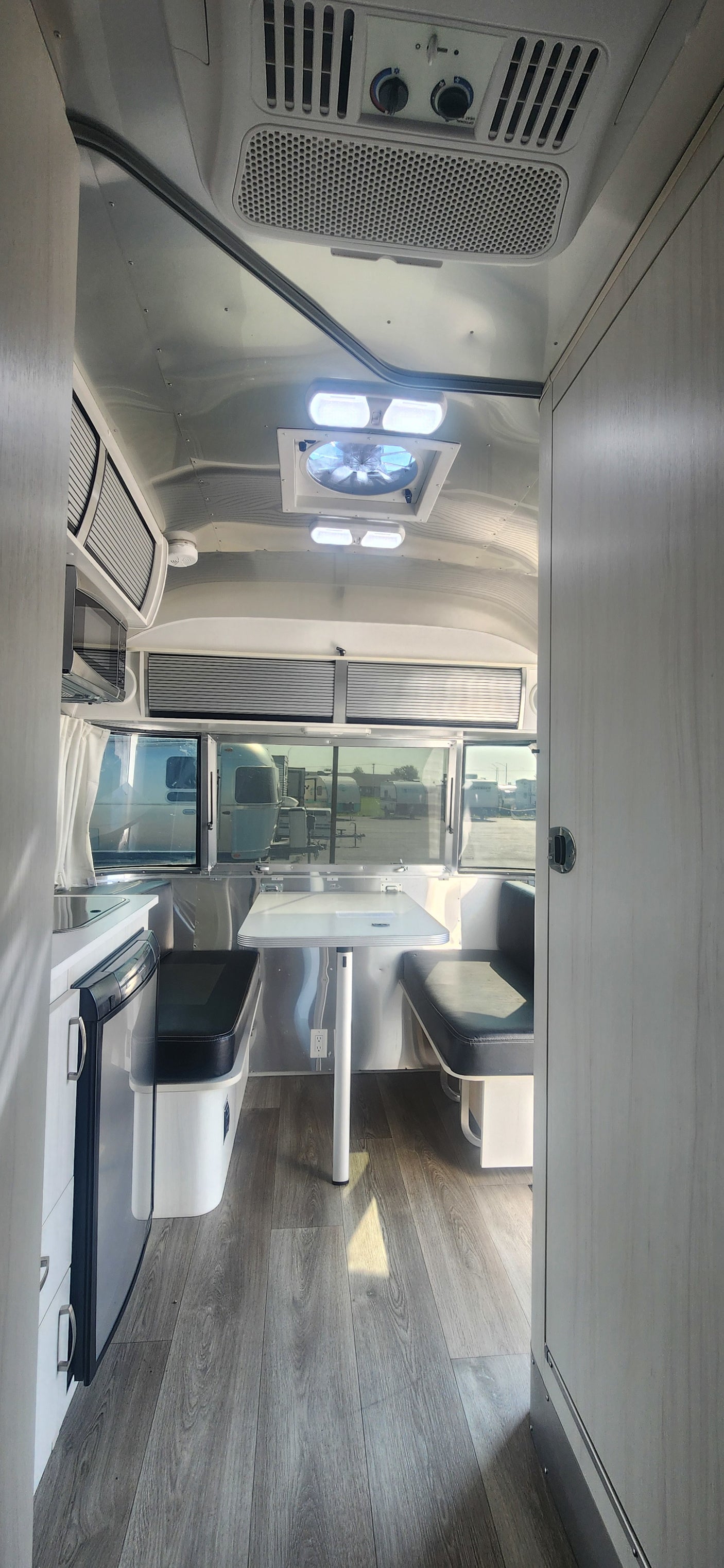 Modern Airstream RV rental interior with kitchen, dining, and stylish design. Perfect for travel adventures.