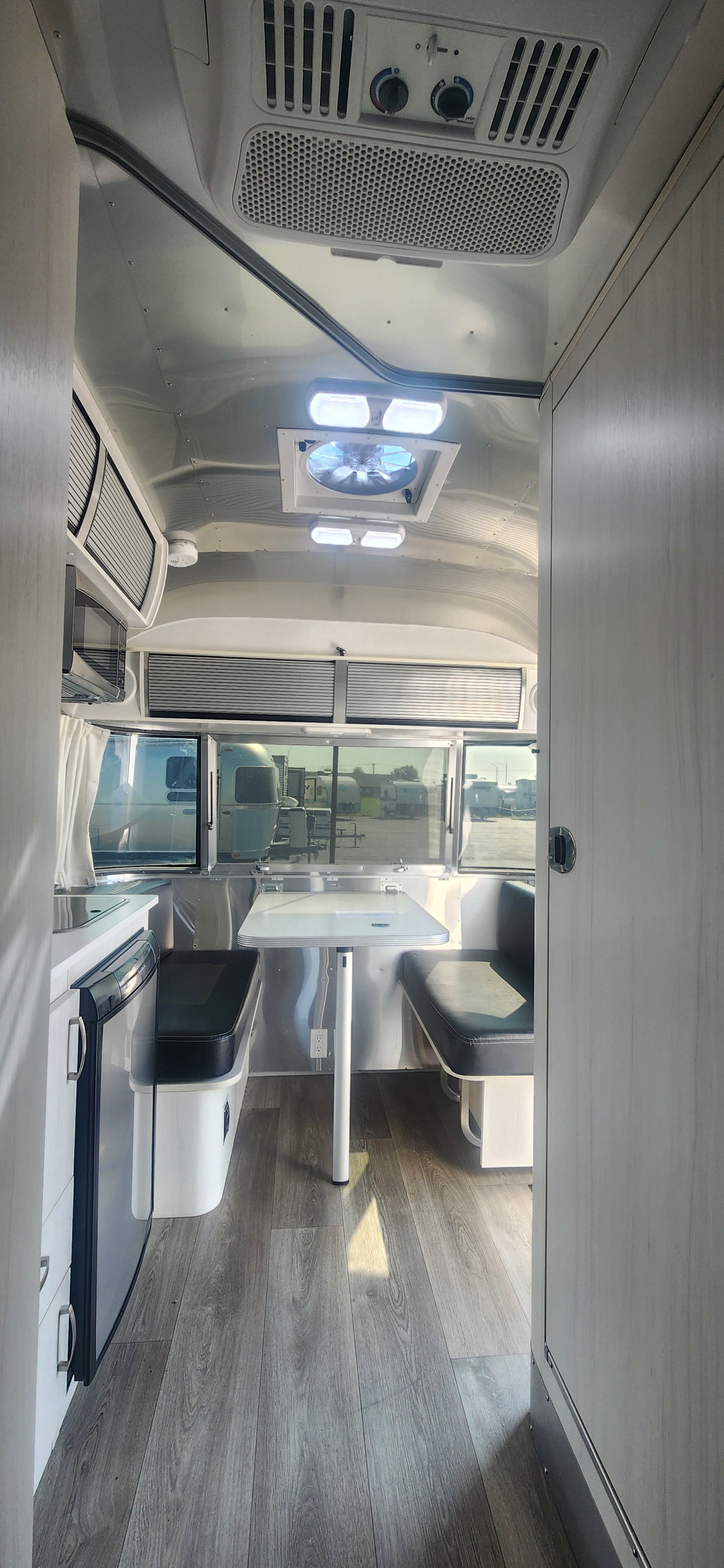 Modern Airstream RV rental interior with kitchen, dining, and stylish design. Perfect for travel adventures.