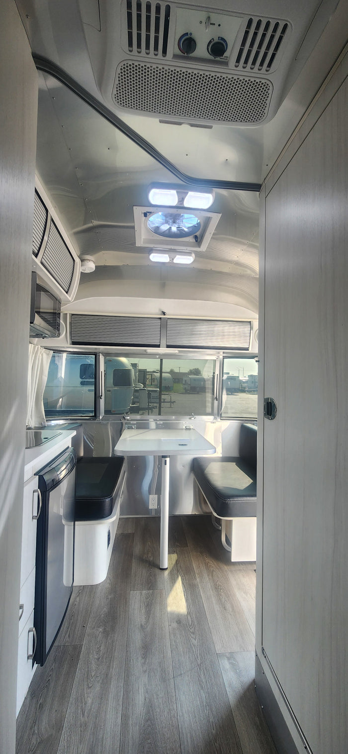 Modern Airstream RV rental interior with kitchen, dining, and stylish design. Perfect for travel adventures.