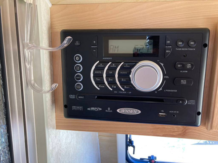 An RV rental's entertainment: A Jensen AWM968 multimedia system, featuring radio, DVD, USB, and Bluetooth audio for your journey.