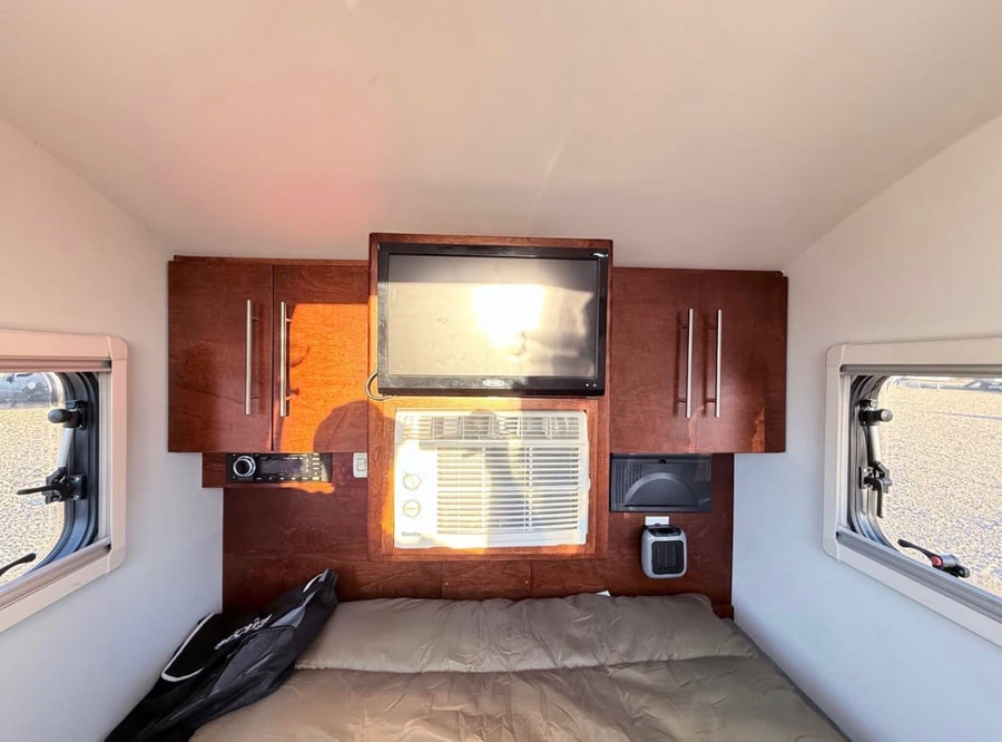 sits on a gravel lot under a clear sky