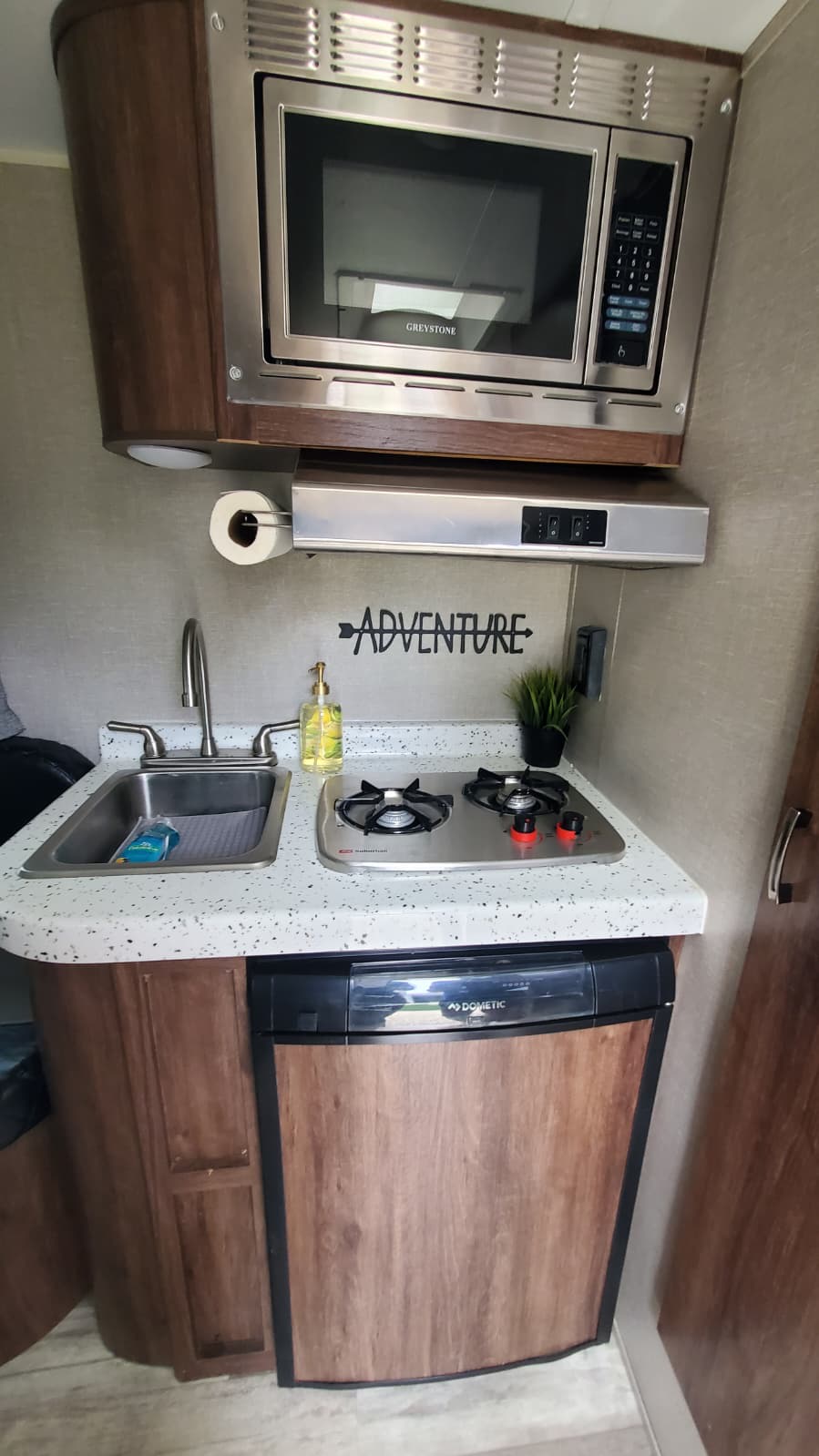 and a "Don't Worry" bumper sticker.|RV rental interior: A bright dinette with a table — photo 6