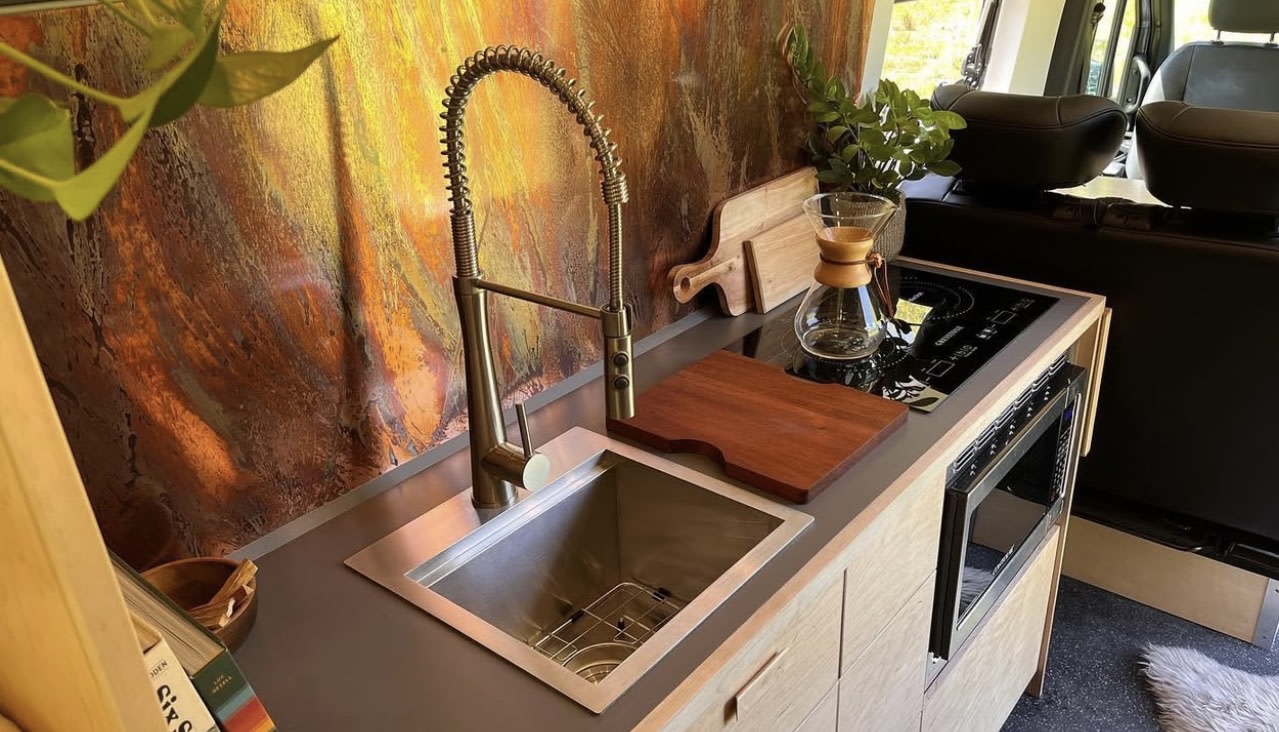 and a cozy raised bed for adventure.|Inside a modern RV rental