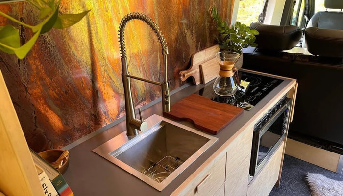 and a cozy raised bed for adventure.|Inside a modern RV rental