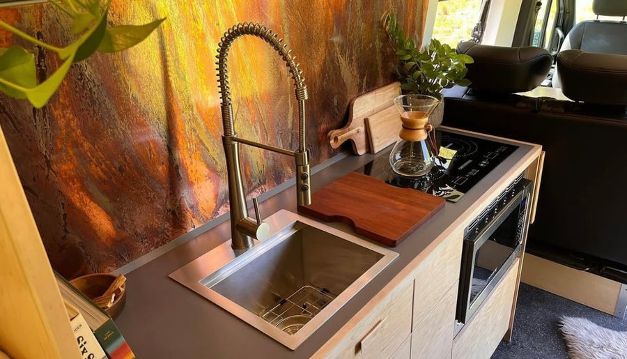 and a cozy raised bed for adventure.|Inside a modern RV rental