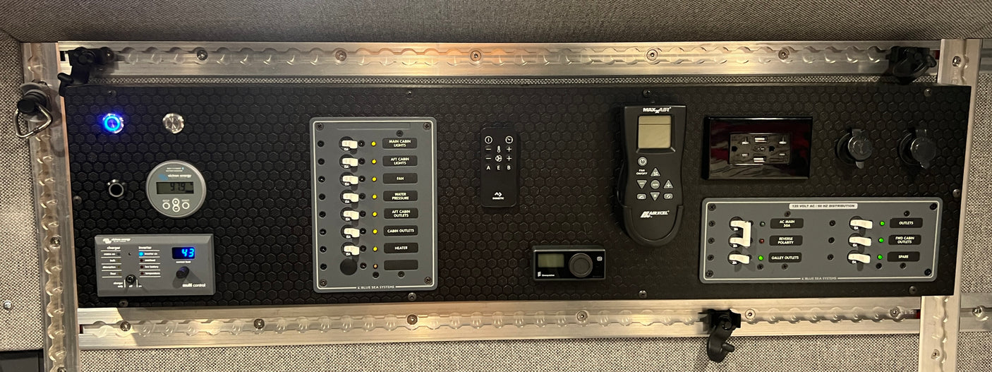 RV rental's comprehensive electrical control center: monitoring, AC/DC panels, climate controls, and outlets.