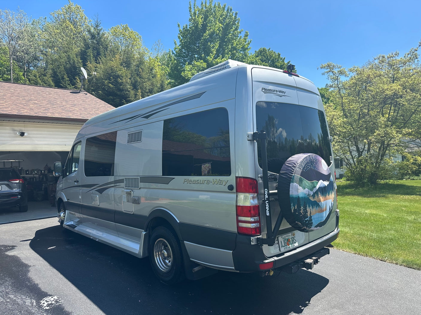 and large windows looking outside.|Spacious RV rental interior with TV