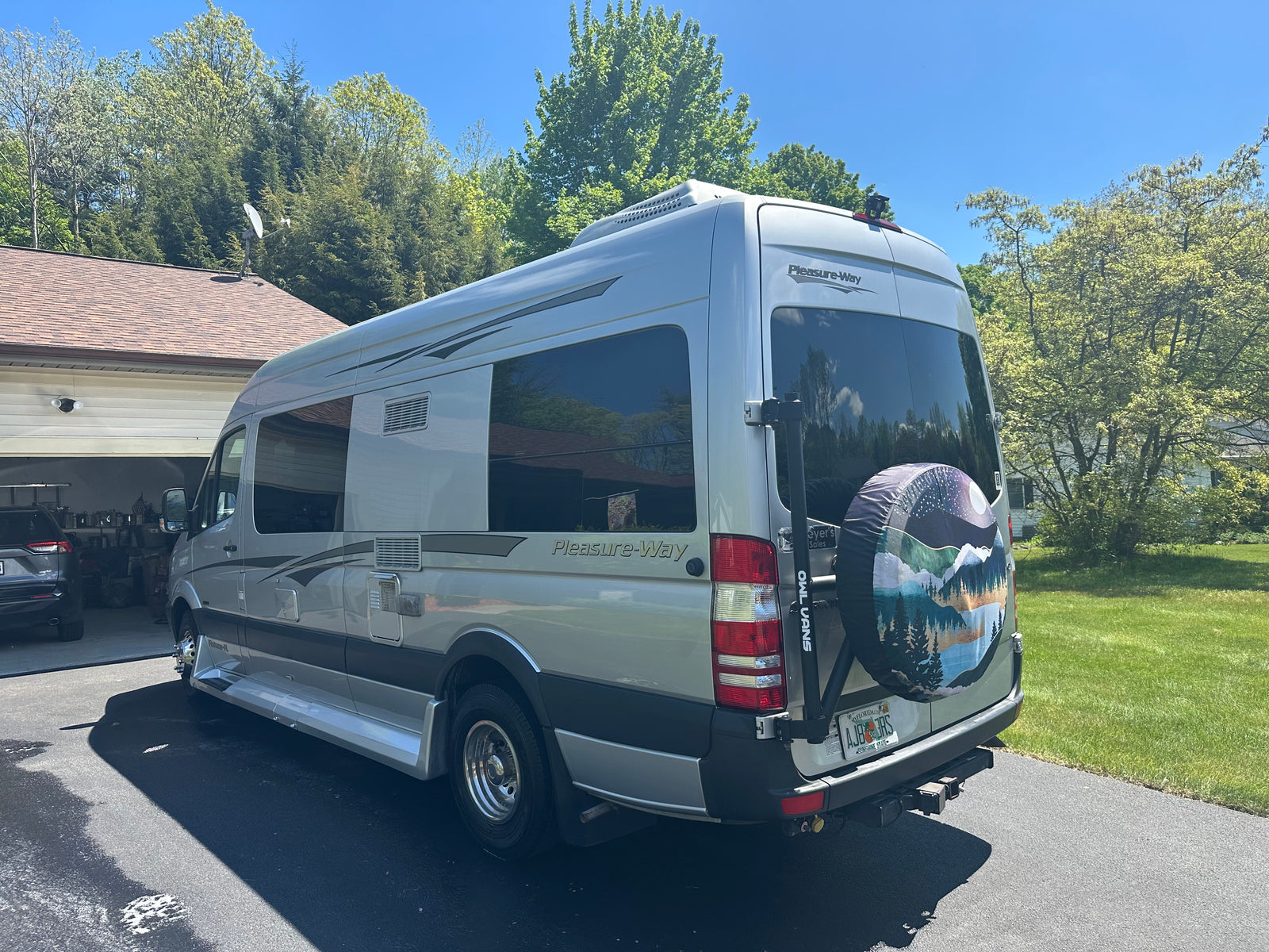 and large windows looking outside.|Spacious RV rental interior with TV