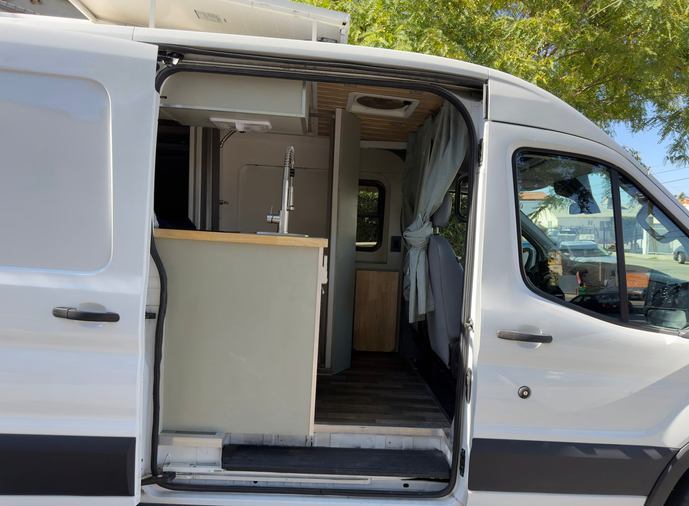 a converted camper van with roof solar panels and AC — photo 1