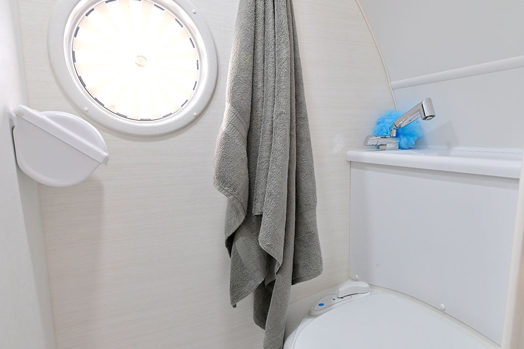 awaits your adventure.|Compact RV rental interior featuring a full kitchenette