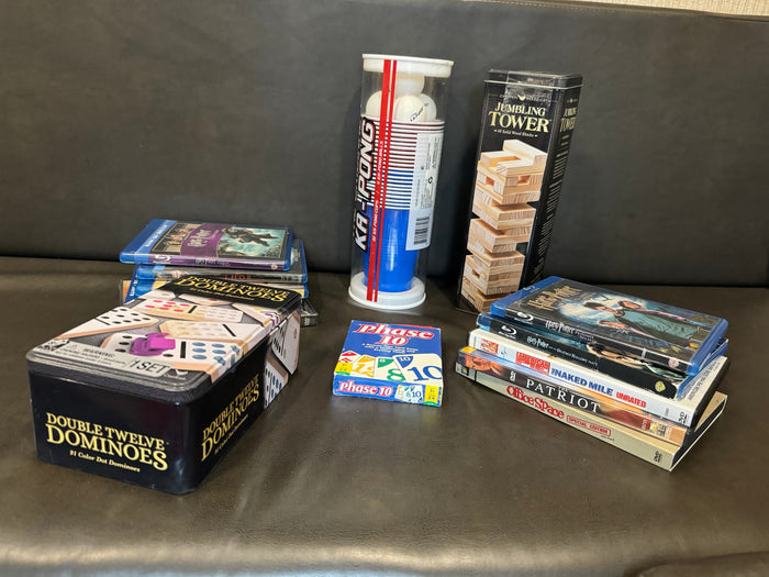 Games & movies perfect for an RV rental: Double Twelve Dominoes, Phase 10, Ka-Pong, Jumbling Tower, & Blu-rays/DVDs.