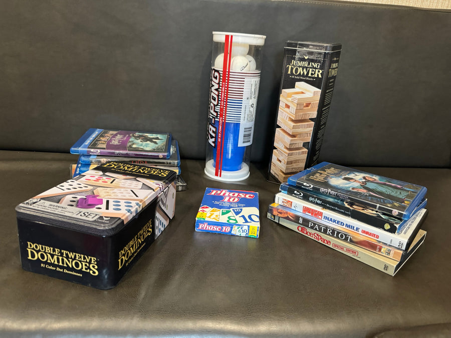 Games & movies perfect for an RV rental: Double Twelve Dominoes, Phase 10, Ka-Pong, Jumbling Tower, & Blu-rays/DVDs.